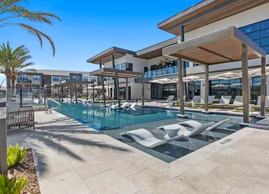 A modern building with a pool in front.