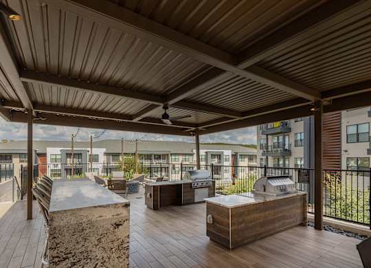 A wooden deck with a grill and a table.