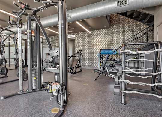 A gym with a variety of equipment including a leg press machine.