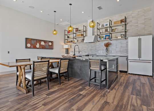 A kitchen with a wooden floor and white walls.