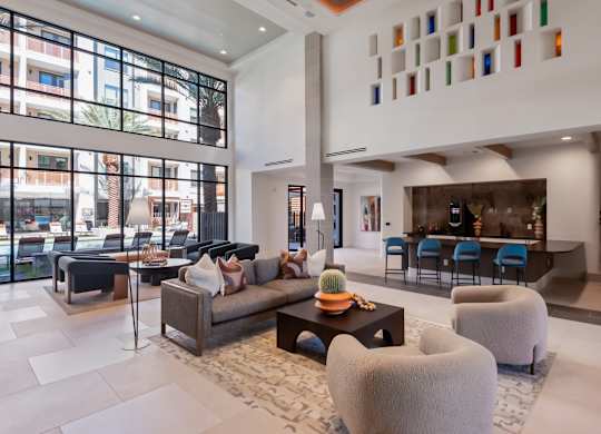 A modern living room with a large window and a couch.