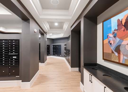 A hallway with a large painting of a bear on the wall.