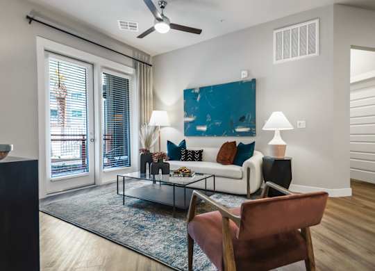 A living room with a brown chair and a blue rug.