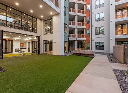 A modern building with a green lawn in front.