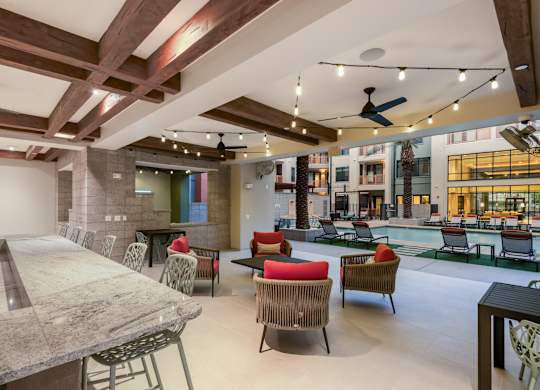 A large room with a pool table and chairs.