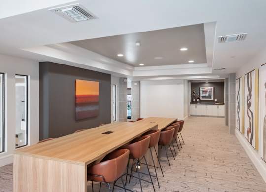 A conference room with a long table and chairs.