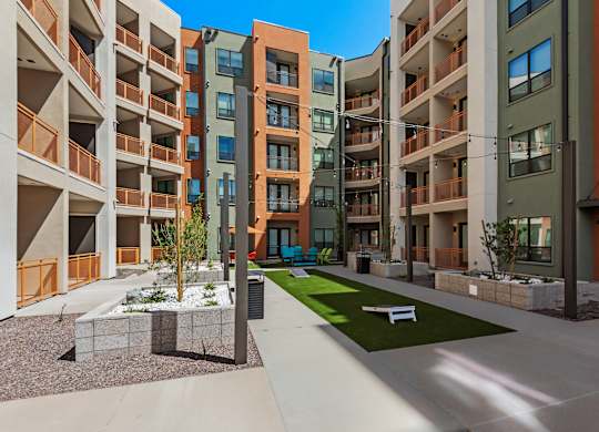 A modern apartment complex with a courtyard and landscaping.