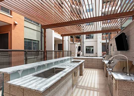 A kitchen with a wooden ceiling and a counter top.