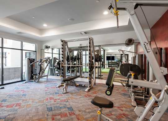 A gym with a variety of equipment including a leg press machine.
