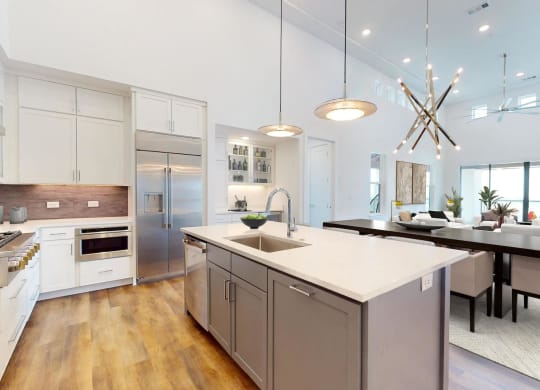 a large kitchen with an island and a dining table
