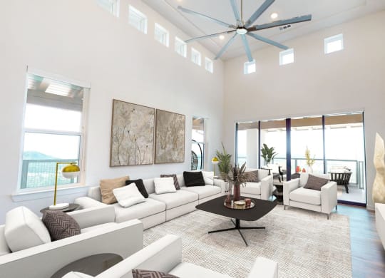 a living room with white furniture and a ceiling fan