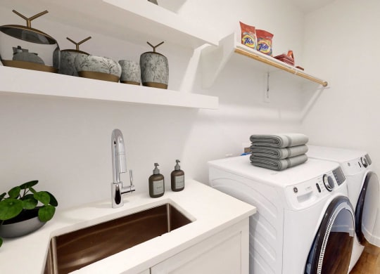 a small laundry room with a washing machine and sink