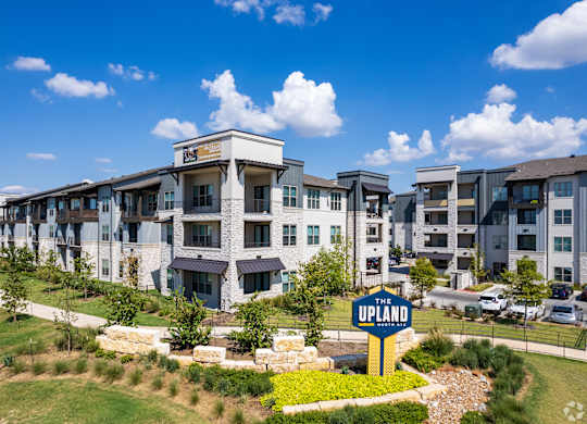 a large apartment building with a sign in front of it