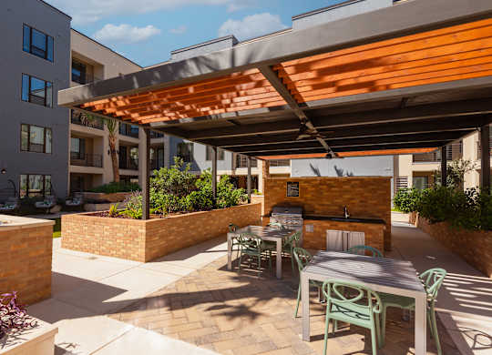 a patio with a table and chairs under awning