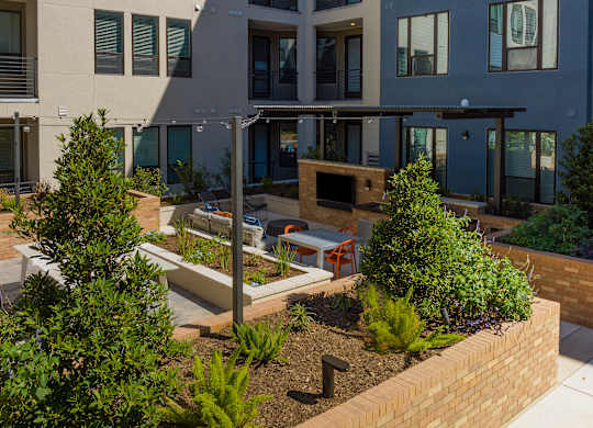 a courtyard with benches and trees in front of a building