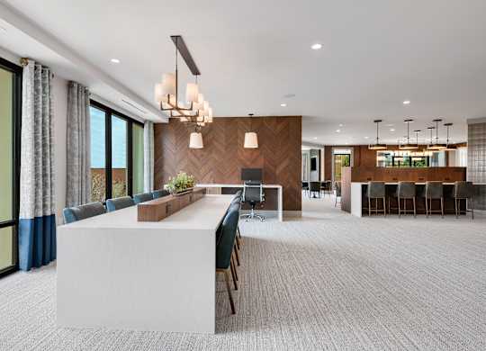 a large room with a long white table and chairs