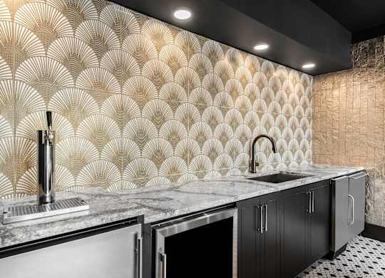 a kitchen with a large counter with a sink and a faucet