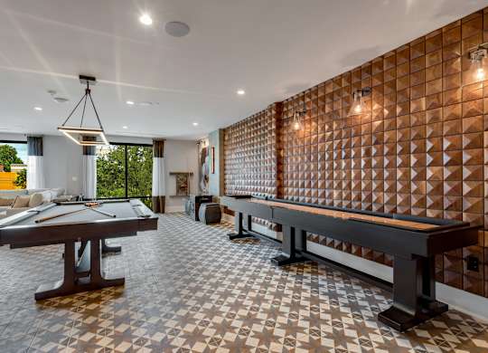 a game room with a pool table and a foosball table