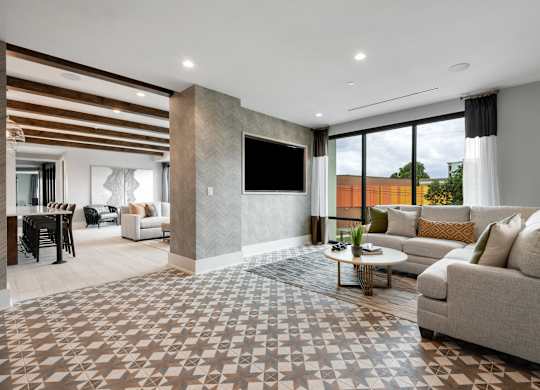 a living room filled with furniture and a large window