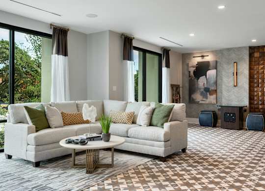 a living room filled with furniture and a large window