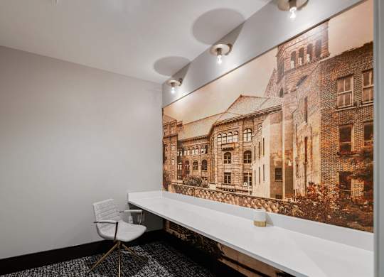 a white desk and chair in a room with a large picture on the wall