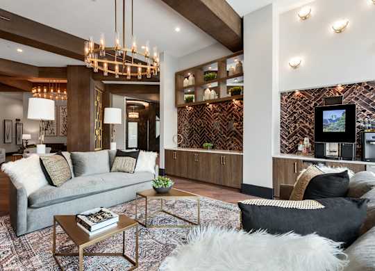 a living room filled with furniture and a large chandelier