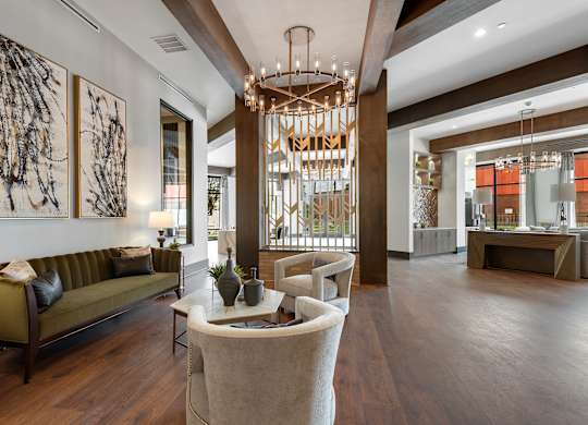a living room filled with furniture and a large chandelier