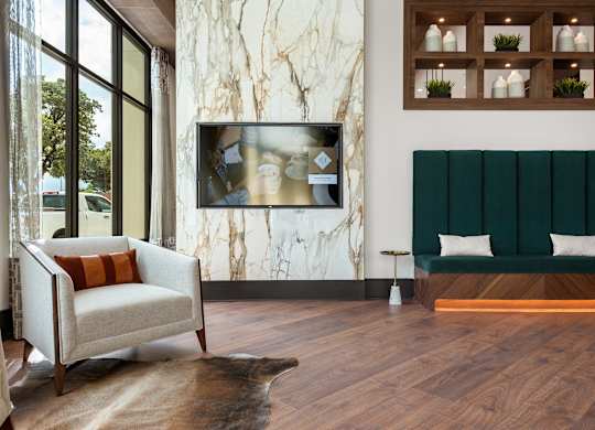 a living room with a sofa and a tv on the wall