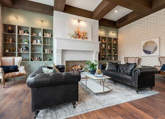 a living room with two leather couches and a fireplace