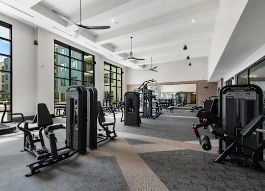 a gym with exercise equipment and windows