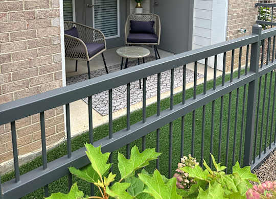 A patio with a table and chairs is visible through a doorway.
