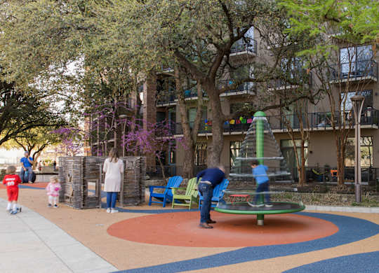 Community playground and outdoor seating area at THE'68 Apartments, Texas, 78205