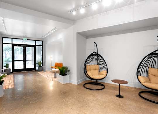 Modern lobby entrance with hanging egg chairs at THE'68 Apartments, San Antonio, TX