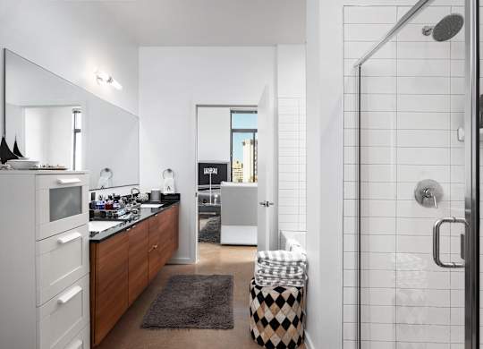 Modern bathroom with walk-in shower at THE'68 Apartments, Texas