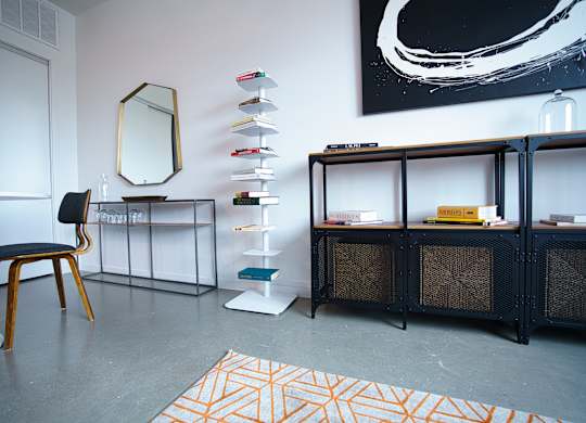 Contemporary living space with industrial storage furniture at THE'68 Apartments, Texas