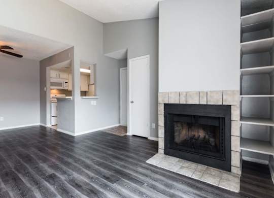 a living room with a fireplace and a book shelf at Northchase, Austin, TX, 78753