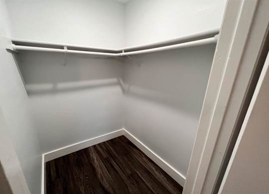 the preserve at ballantyne commons empty closet with wood floor and white walls at Northchase, Austin, TX