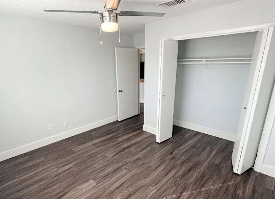 an empty bedroom with a closet and a ceiling fan at Northchase,Texas