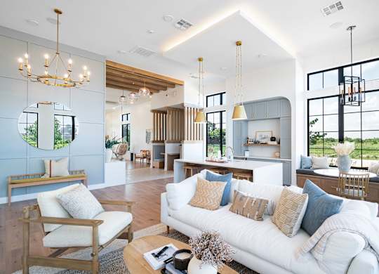 A modern living room with a white sofa and wooden furniture.