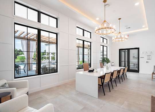 Resident Lounge with a long white table and chairs.