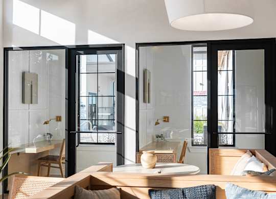 A modern dining area with a table set for two.