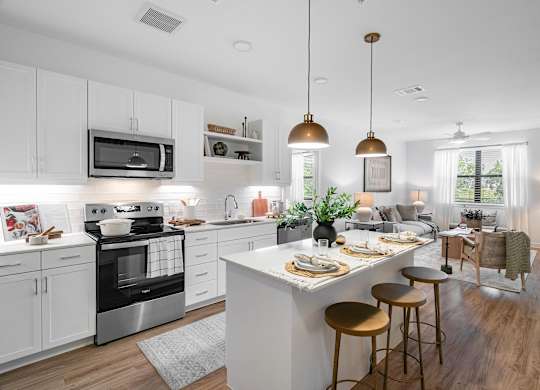 A modern kitchen with a large island and bar stools.