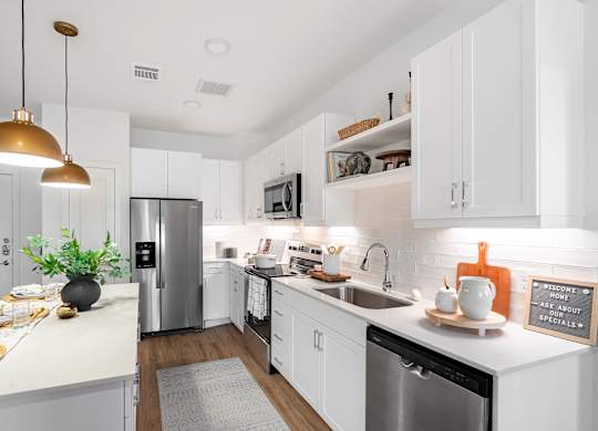 A kitchen with white cabinets and a black dishwasher.