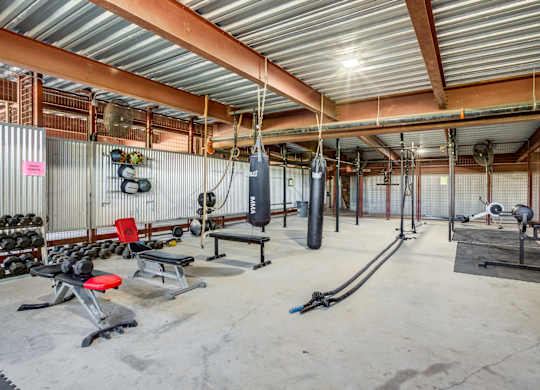 Fitness center with boxing equipment and free weights at 1221 Broadway Lofts Apartments, San Antonio, TX