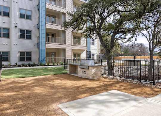 Outdoor grilling area with built in barbecue at Emilia Apartments, Boerne, Texas