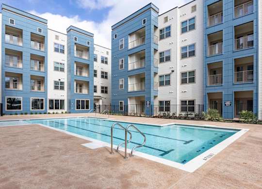 Resort style swimming pool with courtyard seating at Emilia Apartments, Texas, 78006