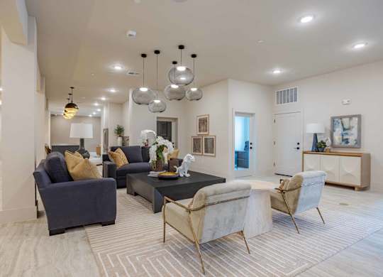 Clubhouse lounge with modern pendant lighting at Emilia Apartments, Boerne, TX