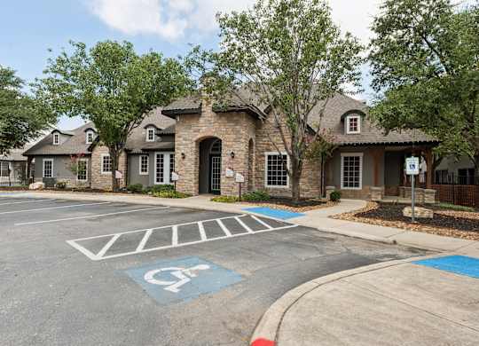 A parking lot with a handicap parking space in front of a building.
