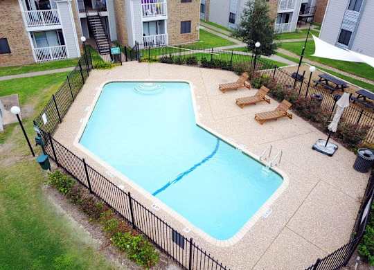an aerial view of a swimming pool in front of an apartment building at Northchase,Texas