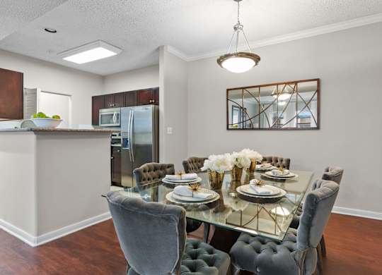 Dining room with glass table and tufted chairs at Melia Medical Center Apartments, Texas, 77054